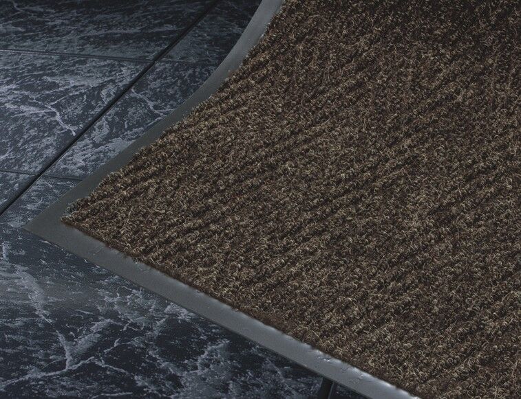 Corner detail of Chevron entrance matting detailing black vinyl edges and herringbone surface pattern in a Chocolate color