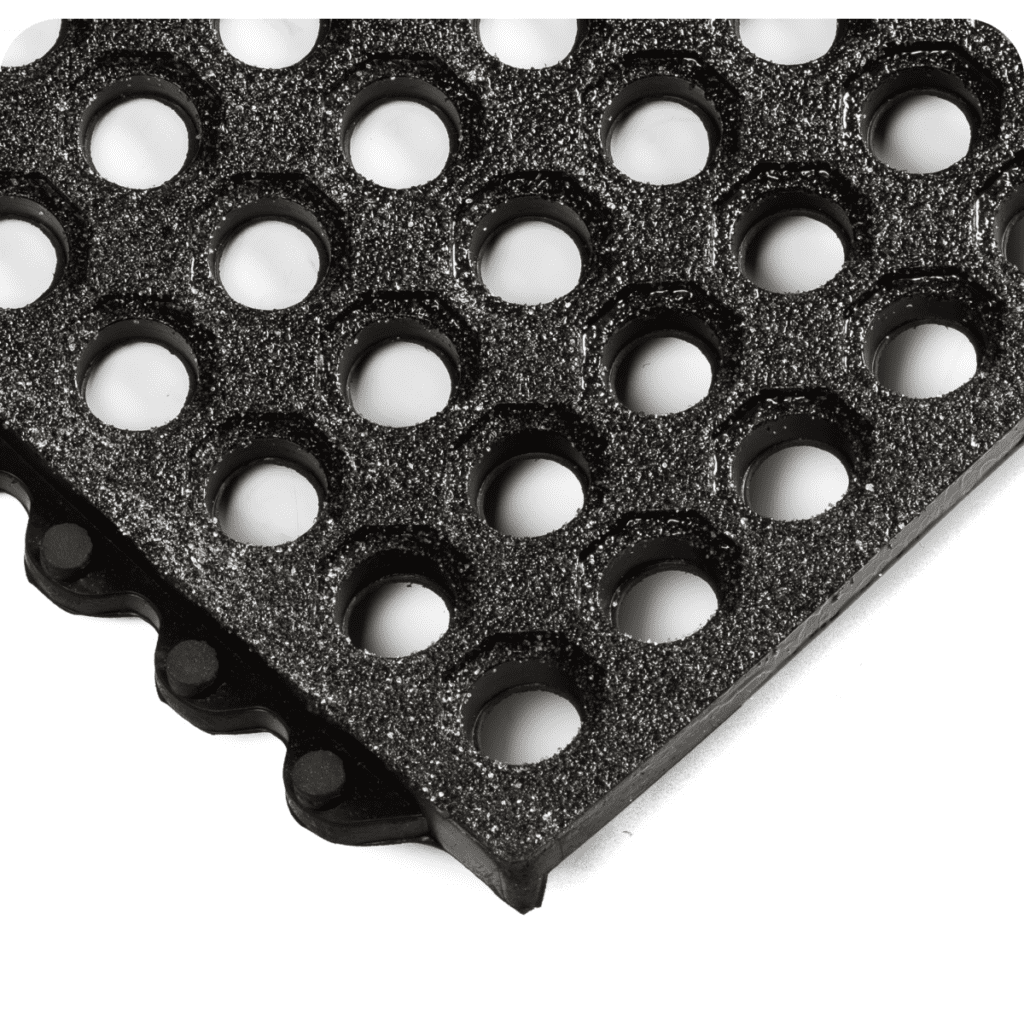 Close up view of 24-7 Nitrile Interlocking anti fatigue mats with gritshield and open design for liquids to fall through the floor mat